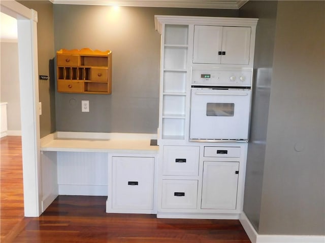 kitchen with dark wood-type flooring, oven, white cabinetry, and open shelves