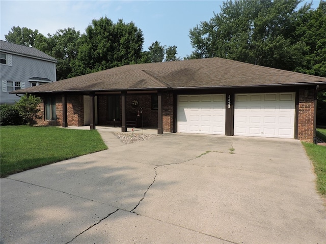 view of front of home with a front lawn and a garage