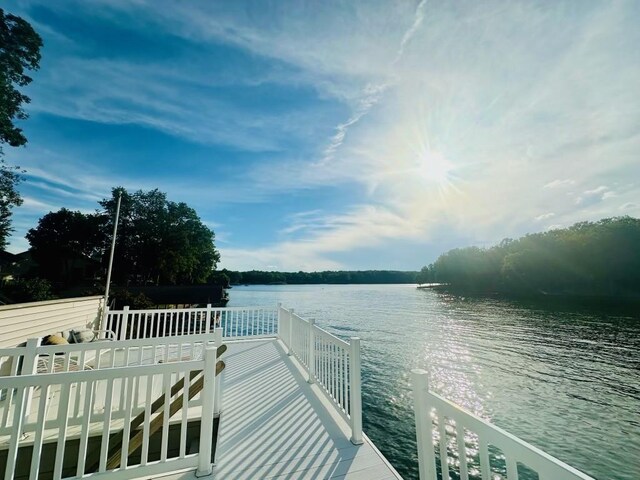 view of dock with a deck with water view