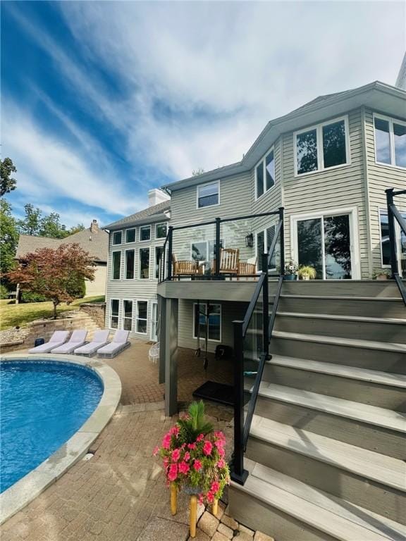 rear view of house with a balcony and a patio area