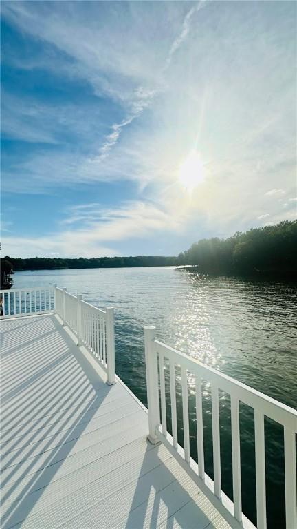 dock area featuring a deck with water view