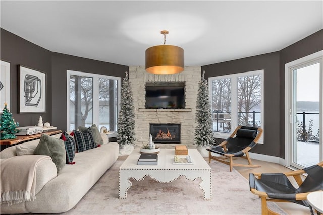 living room with a stone fireplace