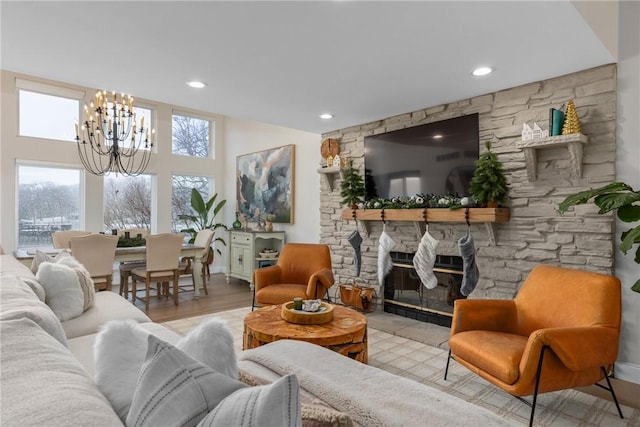 living room with light hardwood / wood-style flooring and an inviting chandelier