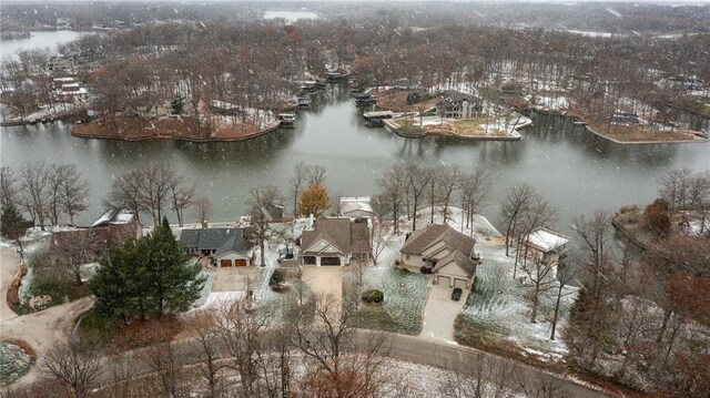 snow covered back of property with a deck