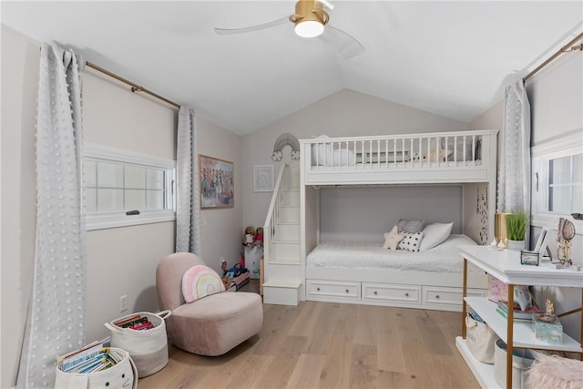 bedroom featuring light wood-type flooring, ceiling fan, and lofted ceiling