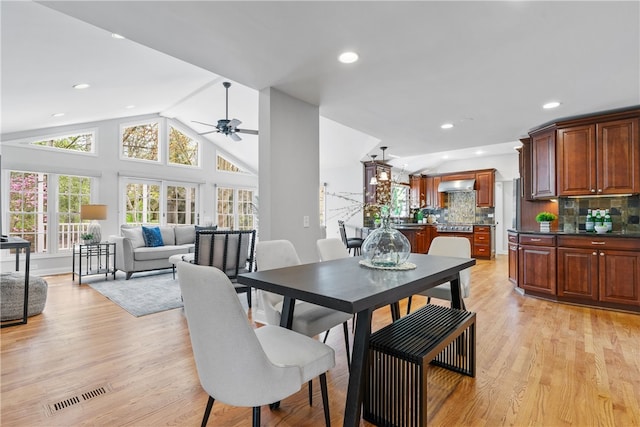 dining area with visible vents, light wood-style floors, recessed lighting, a ceiling fan, and vaulted ceiling