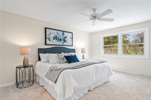 carpeted bedroom featuring baseboards, visible vents, and ceiling fan
