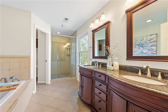 bathroom featuring a sink, tile patterned flooring, a stall shower, and double vanity