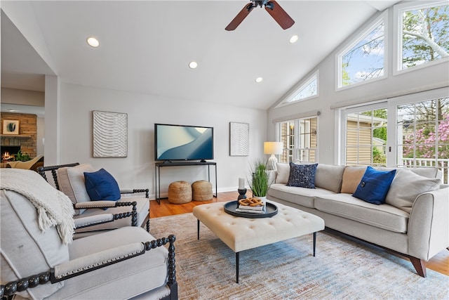 living room featuring a ceiling fan, high vaulted ceiling, recessed lighting, and wood finished floors