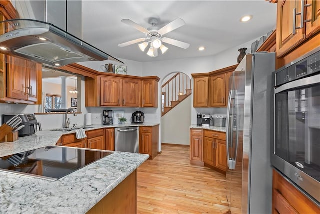 11154 E Ravenwood Ct, Effingham, IL 62401 - kitchen featuring stainless steel appliances, brown cabinetry, a ceiling fan, light wood-type flooring, and recessed lighting