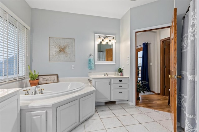 11154 E Ravenwood Ct, Effingham, IL 62401 - full bath with vanity, tile patterned flooring, and a garden tub