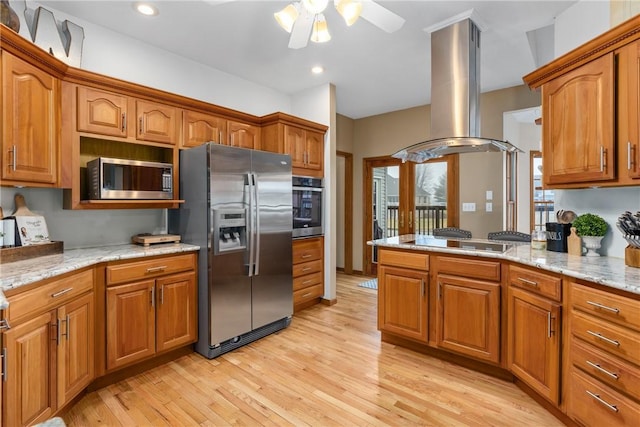 11154 E Ravenwood Ct, Effingham, IL 62401 - kitchen featuring appliances with stainless steel finishes, island range hood, ceiling fan, brown cabinetry, and recessed lighting