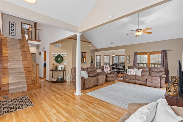 11154 E Ravenwood Ct, Effingham, IL 62401 - living room with high vaulted ceiling, stairs, wood finished floors, ceiling fan, and decorative columns