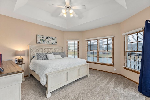 11154 E Ravenwood Ct, Effingham, IL 62401 - bedroom with a tray ceiling, light colored carpet, multiple windows, and ceiling fan
