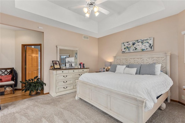 11154 E Ravenwood Ct, Effingham, IL 62401 - bedroom featuring light carpet, ceiling fan, and a raised ceiling