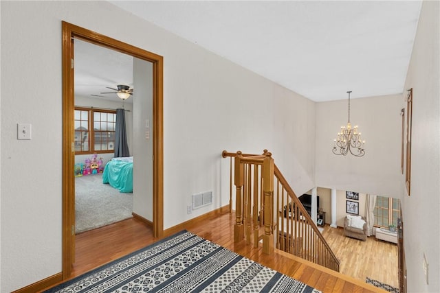 11154 E Ravenwood Ct, Effingham, IL 62401 - stairway featuring wood finished floors, a chandelier, and a ceiling fan