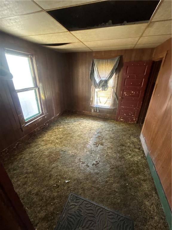 1525 N St, Decatur, IL 62521 - unfurnished room featuring a paneled ceiling and wooden walls