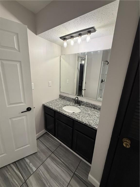 bathroom with vanity and a textured ceiling