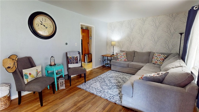 714 Parras St, Danville, IL 61832 - living room featuring wallpapered walls, an accent wall, and wood finished floors