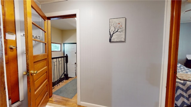714 Parras St, Danville, IL 61832 - corridor featuring light wood finished floors and an upstairs landing