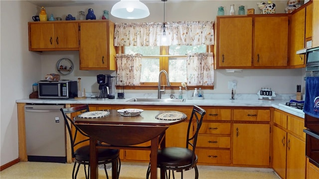714 Parras St, Danville, IL 61832 - kitchen with stainless steel appliances, light countertops, and brown cabinets