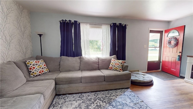 714 Parras St, Danville, IL 61832 - living room with wood finished floors, wallpapered walls, and an accent wall