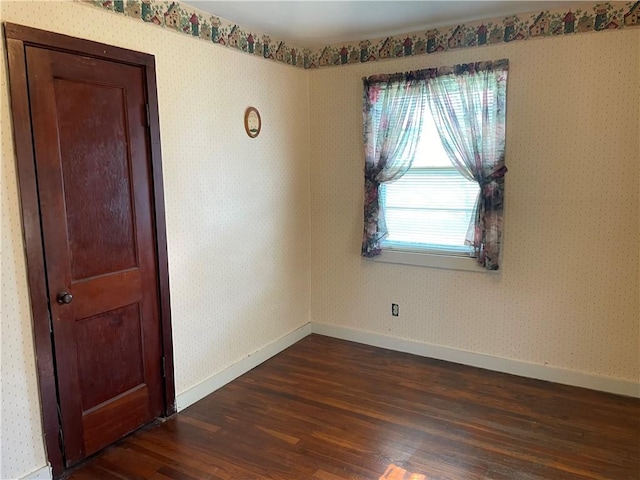 510 W Elm St, Hoopeston, IL 60942 - empty room with dark wood-style flooring and wallpapered walls