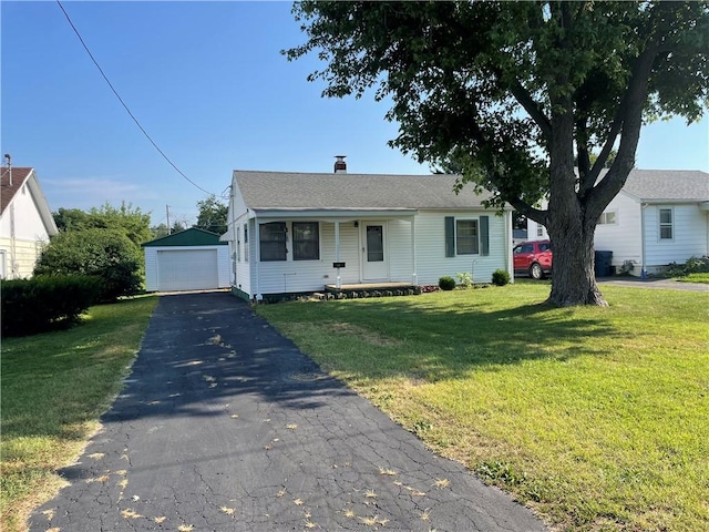 510 W Elm St, Hoopeston, IL 60942 - view of front of home featuring a garage, an outbuilding, a front lawn, driveway, and a porch