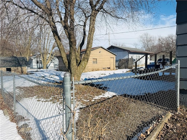 snowy yard featuring a storage unit