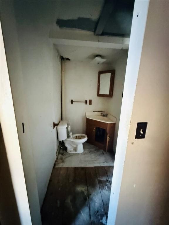 bathroom with vanity, toilet, and hardwood / wood-style floors