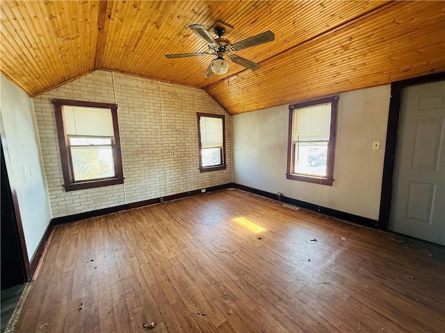 empty room featuring wood ceiling, brick wall, ceiling fan, dark hardwood / wood-style floors, and lofted ceiling