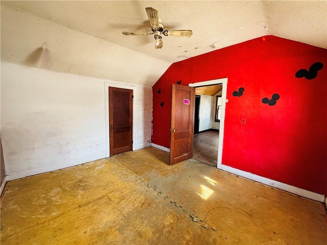 bonus room featuring ceiling fan, a textured ceiling, and lofted ceiling