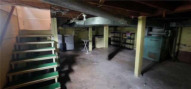 basement with separate washer and dryer and heating unit