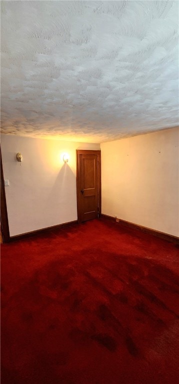 carpeted spare room with a textured ceiling