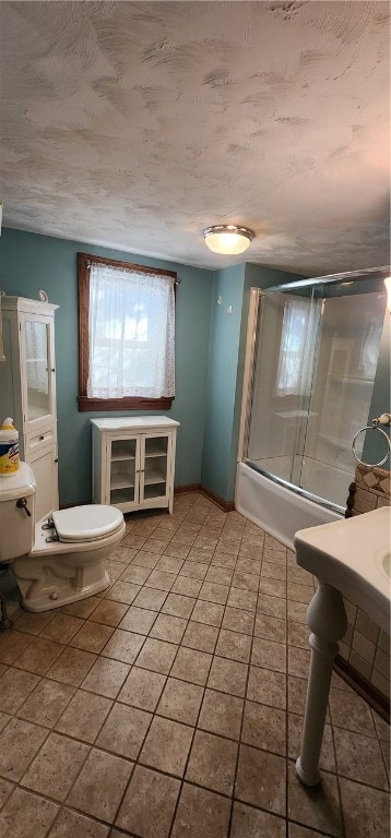 bathroom with shower / bath combination with glass door, tile patterned floors, and toilet