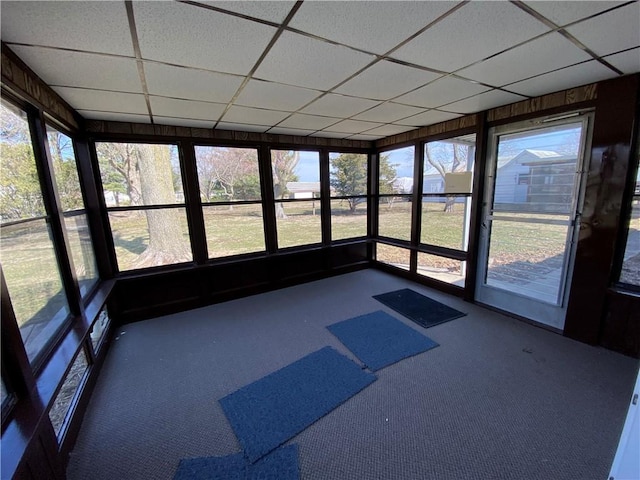 unfurnished sunroom with a drop ceiling