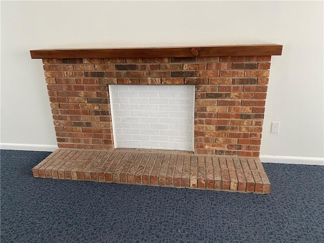 details with a brick fireplace, carpet flooring, and baseboards