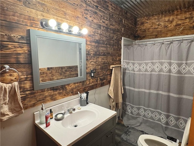 bathroom with vanity, wooden ceiling, toilet, and wooden walls