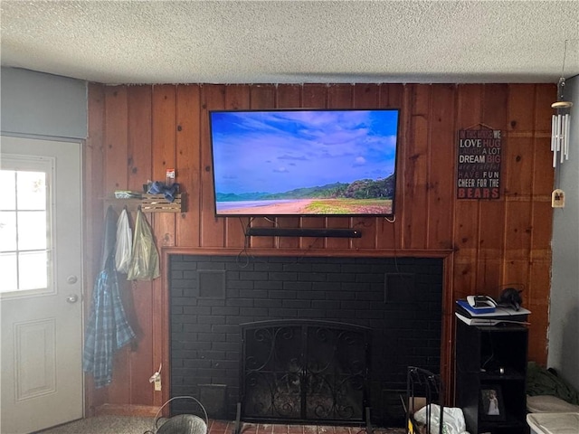 interior details with a fireplace, wood walls, and a textured ceiling