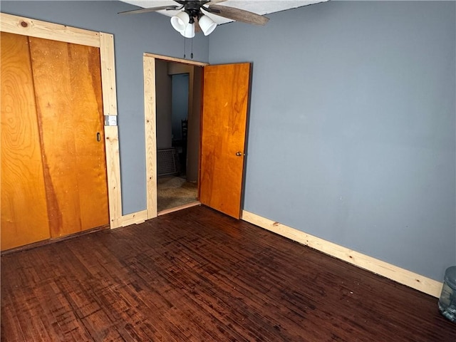 unfurnished bedroom featuring dark hardwood / wood-style flooring and ceiling fan