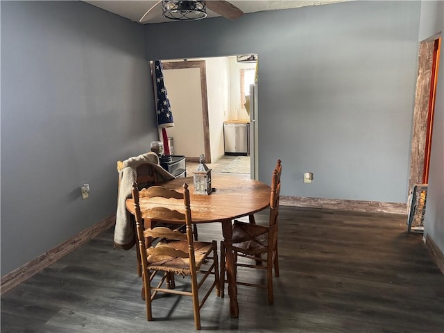 dining area with ceiling fan and dark wood-type flooring