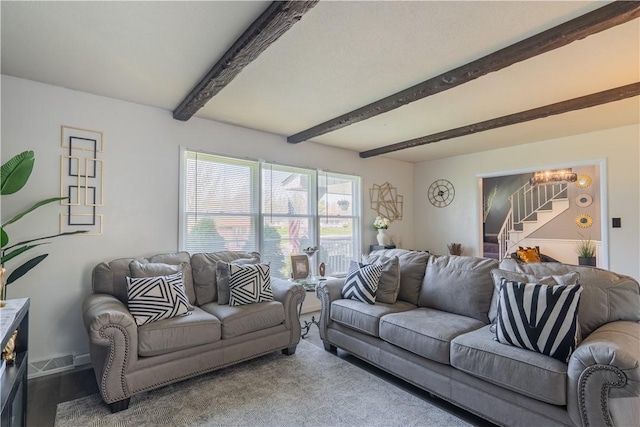 living room with baseboards, visible vents, stairs, and beam ceiling