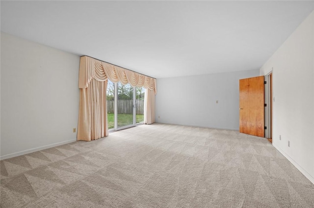 carpeted empty room with baseboards