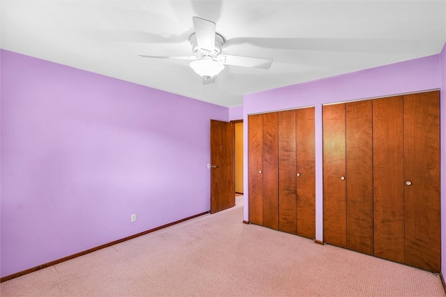 unfurnished bedroom with ceiling fan and light colored carpet