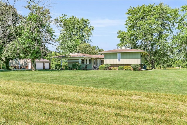 view of yard with a garage and an outdoor structure