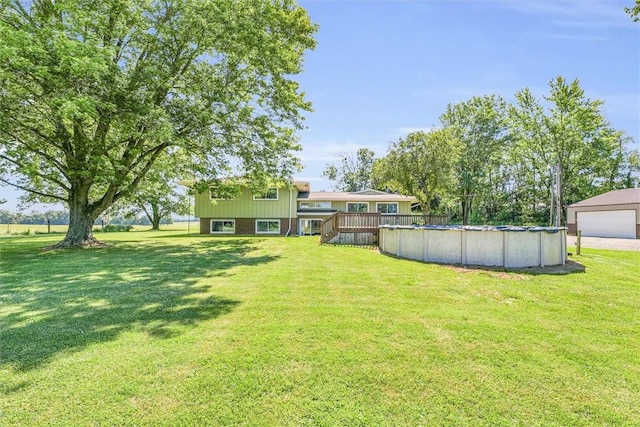 1283 N 1400 E Rd, Shelbyville, IL 62565 - view of grassy yard with a wooden deck, a garage, and a covered pool
