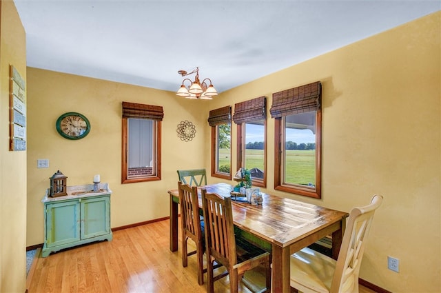 dining area with a chandelier and light hardwood / wood-style floors