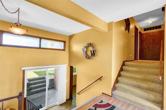 staircase featuring hardwood / wood-style flooring