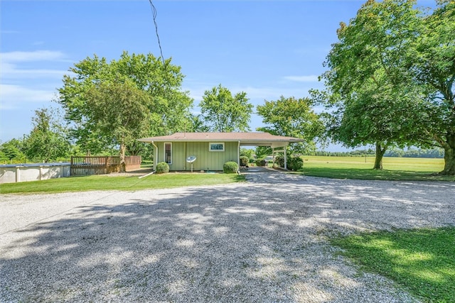 view of front of property featuring a carport and a front lawn