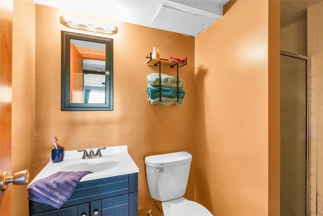 bathroom featuring vanity, an enclosed shower, and toilet